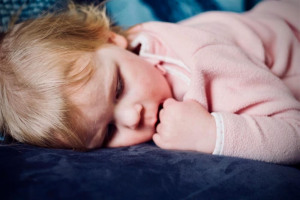 child-in-pink-lying-down.jpg - Packs of Joy helping vulnerable families