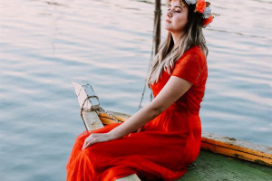 caique-silva-woman-sitting-on-boat-in-body-of-water-while-closing-her-eyes.jpg - That Dress! 