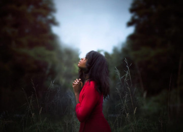 diana-simumpande-woman-wearing-red-sweatshirt-looking-at-top-between-trees-near-grass-during-daytime.jpg