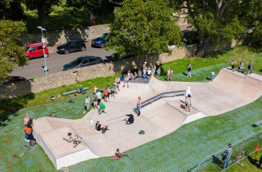 People skateboarding in a new skateboard ring.