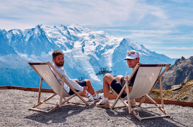 People sitting looking at mountains.