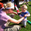 parent-holds-child-over-the-scrunchy-in-sunshine-1.jpg